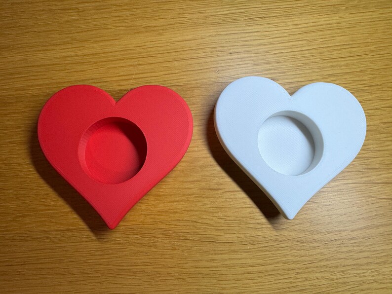 3D printed heart-shaped tealight holder with smooth, realistic, rounded edges. Perfect for LED or real flame candles. Available in various colours and pack sizes. Ideal for Valentine’s Day, romantic gifts, anniversaries, or cosy home decor.