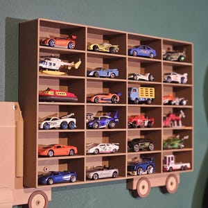 3D-printed truck-themed wall shelf with wooden finish PLA, designed for car storage. Ideal for adult and child car collectors to organise and display collectables neatly in 24 compartments. Oak and Pine effect colour