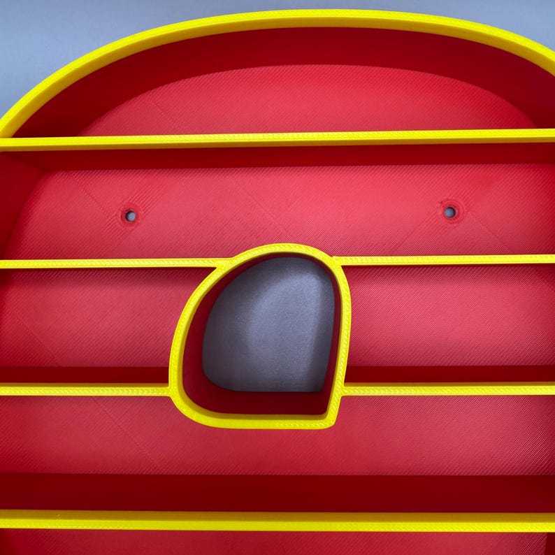 May include: A red and yellow 3D-printed wall shelf with a unique design. The shelf features a rounded top and a central opening, with several horizontal shelves. The edges are outlined in yellow, creating a striking contrast.