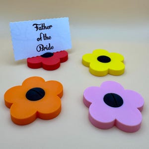 A selection of flower shaped floral place card holders, 3d printed. Perfect for weddings or restaurants that want a unique personalised event or wedding. For holding cards such as 'groom' 'bride' 'father of the bride' etc
