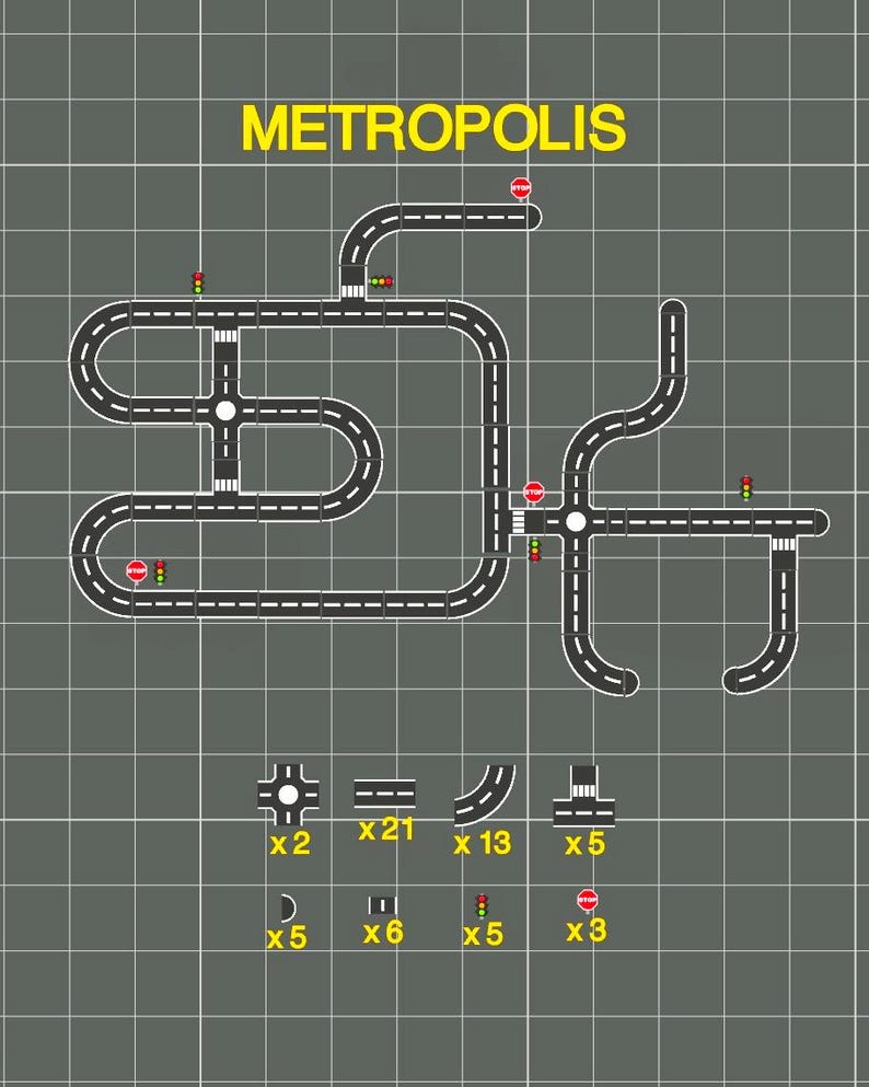 May include: A diagram of a city road network labeled "METROPOLIS" in yellow. The network includes roads, intersections, traffic lights, and stop signs. Various road pieces and accessories are shown below the network.
