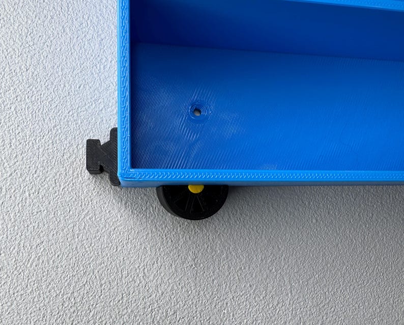 Close up of the wheels and bumpers/connectors attached to the shelf