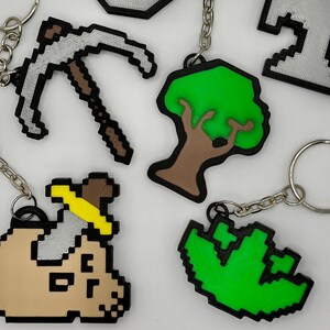 3D printed Old School RuneScape skill icon keychains featuring pixelated designs. Includes skills Mining, Herblore, defense, slayer, woodcutting and smithing. Perfect for RuneScape fans to show off their love for the game with durable accessories.