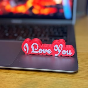 3D printed ‘I Love You’ sign with bold red and white 3D letters. A perfect Valentine’s Day gift, romantic decor, or anniversary present. Unique, high-quality design makes it ideal for bedroom decor, couples’ gifts, or special celebrations of love.