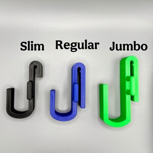 May include: Three plastic hooks in different sizes: slim, regular, and jumbo. The hooks are black, blue, and green.