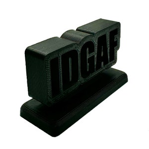 Sleek black 3D printed 'IDGAF' sign, versatile for desk, shelf, or trophy display, with sharp, standout lettering.