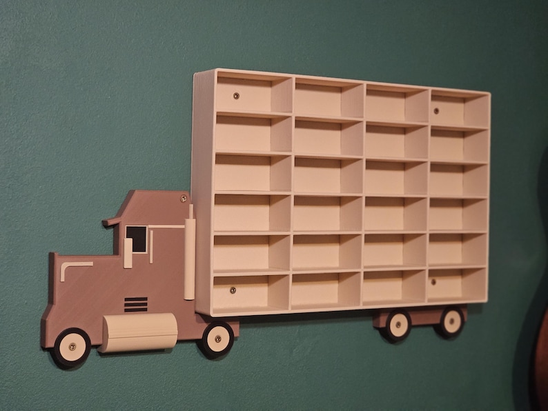 3D-printed truck-themed wall shelf with wooden finish PLA, designed for car storage. Ideal for adult and child car collectors to organise and display collectables neatly in 24 compartments. A functional decor piece that adds charm to any room.