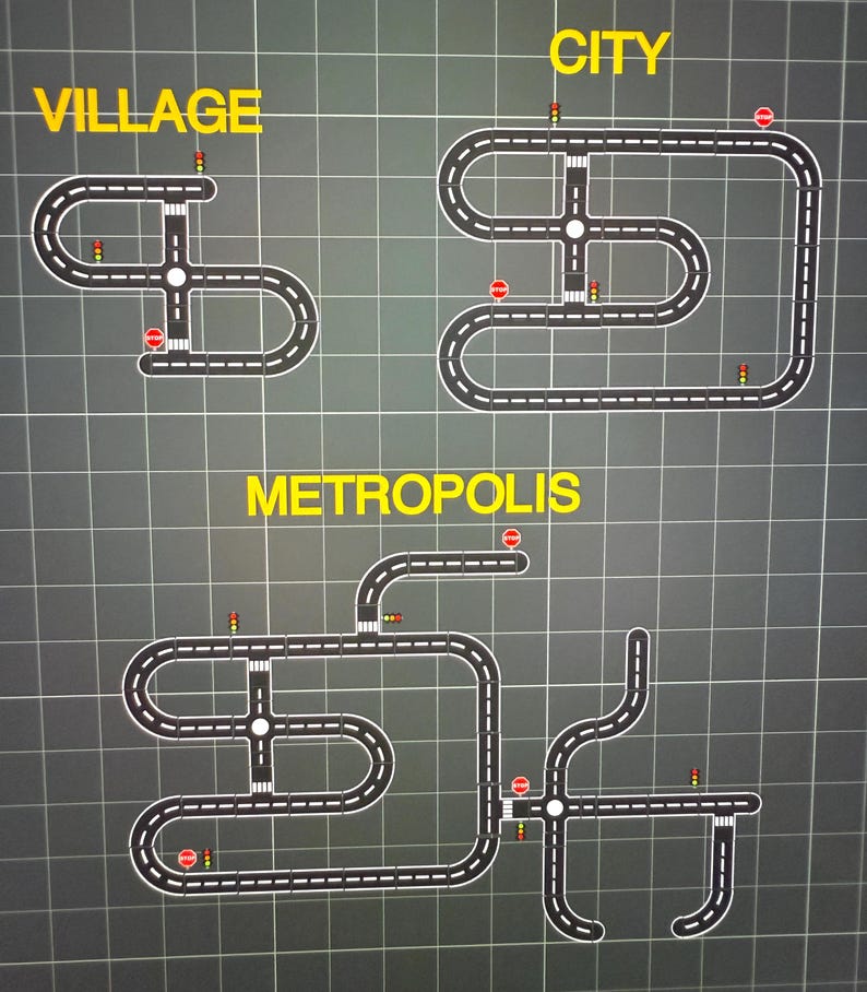 May include: A graphic of three road layouts labeled "Village", "City", and "Metropolis". Each layout features roads with stop signs, traffic lights, and intersections, all set against a grid background. The text is in yellow.