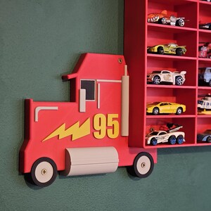 Red Disney-inspired toy car storage truck with shelving, perfect for holding Hot Wheels or Matchbox cars. This fun practical display is a great way to organise a child’s room while encouraging creativity and play. Available in customisable colours.