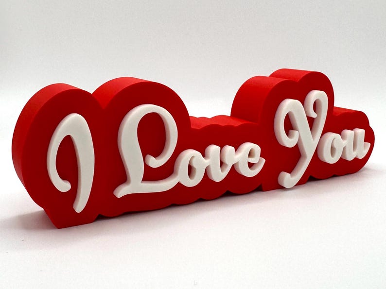 3D printed ‘I Love You’ sign with bold red and white 3D letters. A perfect Valentine’s Day gift, romantic decor, or anniversary present. Unique, high-quality design makes it ideal for bedroom decor, couples’ gifts, or special celebrations of love.