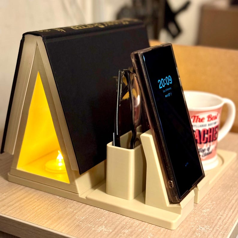 bedside storage organiser with book rest, phone stand, and pen holder. Versatile design with a built-in LED tea light slot for soft lighting. Perfect for keeping nightstand essentials neat and accessible. 3D printed, durable, and lightweight.