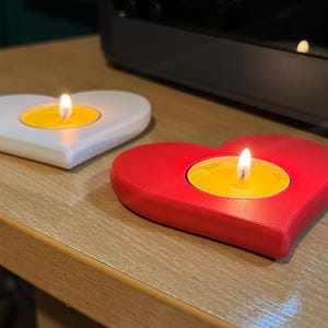 3D printed heart-shaped tealight holder with smooth, realistic, rounded edges. Perfect for LED or real flame candles. Available in various colours and pack sizes. Ideal for Valentine’s Day, romantic gifts, anniversaries, or cosy home decor.