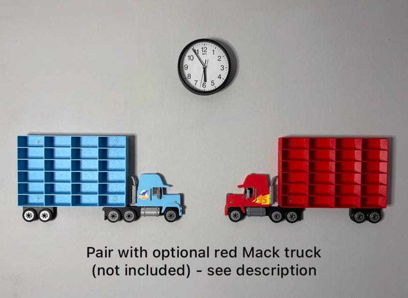 May include: Two toy semi-trucks, one light blue and one red, are displayed against a gray background. The blue truck has a blue grid-like trailer, and the red truck has a red grid-like trailer. A black clock hangs above the trucks.