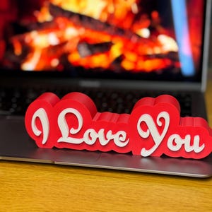 3D printed ‘I Love You’ sign with bold red and white 3D letters. A perfect Valentine’s Day gift, romantic decor, or anniversary present. Unique, high-quality design makes it ideal for bedroom decor, couples’ gifts, or special celebrations of love.
