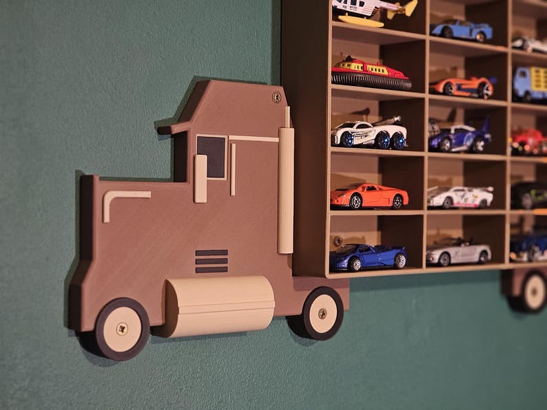 3D-printed truck-themed wall shelf with wooden finish PLA, designed for car storage. Ideal for adult and child car collectors to organise and display collectables neatly in 24 compartments. A functional decor piece that adds charm to any room.