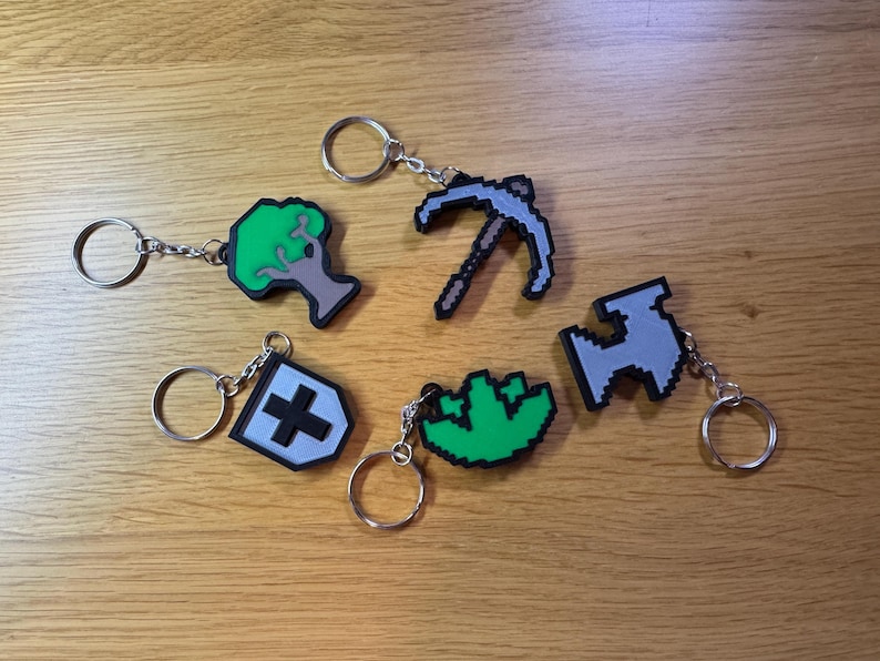 3D printed Old School RuneScape skill icon keychains featuring vibrant, pixelated designs. Includes iconic skills like Mining, Herblore, and defense. Perfect for RuneScape fans to show off their love for the game as stylish and durable accessories.