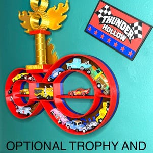 May include: A red and blue infinity-shaped shelf unit displaying toy cars. A gold trophy with flames and a sign that reads "Thunder Hollow" are also present. The text "OPTIONAL TROPHY AND SIGN - See Description" is at the bottom.