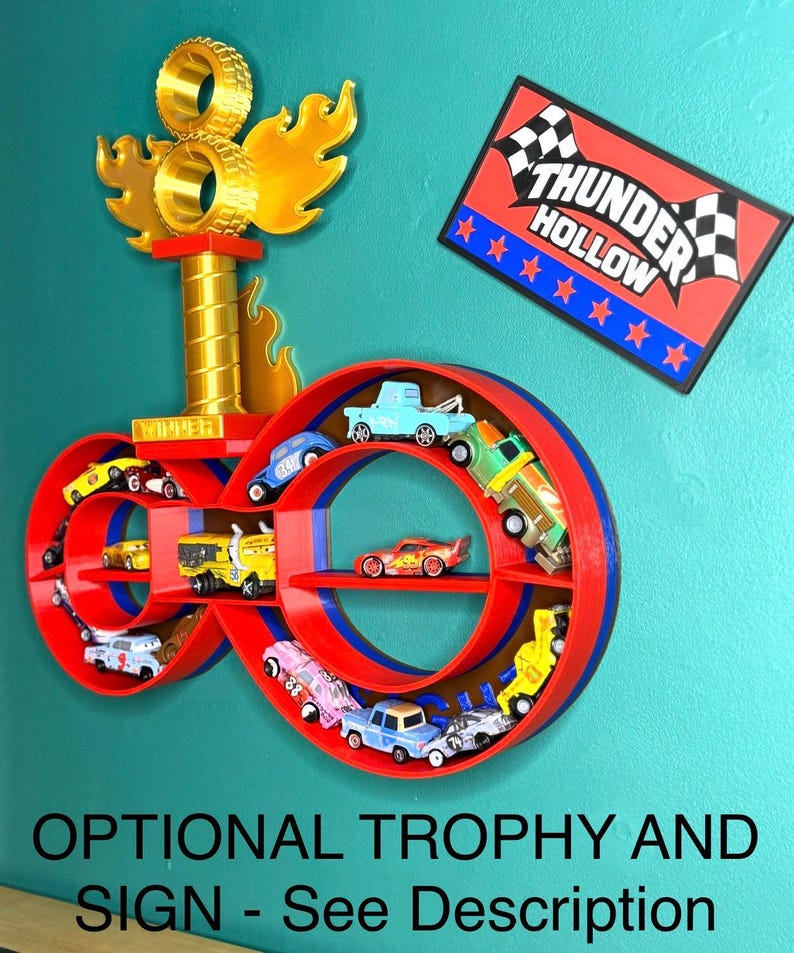 May include: A red and blue infinity-shaped shelf unit displaying toy cars. A gold trophy with flames and a sign that reads "Thunder Hollow" are also present. The text "OPTIONAL TROPHY AND SIGN - See Description" is at the bottom.