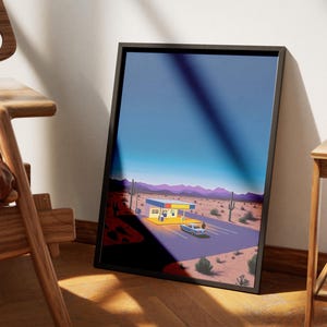 May include: A framed print of a desert landscape with a yellow and blue building and a car driving away. The sky is a gradient of blue and purple.