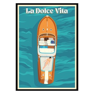 May include: A framed poster featuring a top-down view of a wooden motorboat on turquoise water. The boat has a person sunbathing on the deck. The words "La Dolce Vita" are at the top.