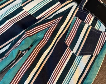May include: Striped pants with a black belt. The pants have white, teal, black, and red stripes.