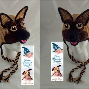 May include: A brown and black crocheted dog hat with a pink nose and black eyes. The hat has a long tie with black and brown stripes. The hat is on a white mannequin head. The image also includes a bookmark with the text "Desert Diamond Crochet" and "Let the Magic Begin."