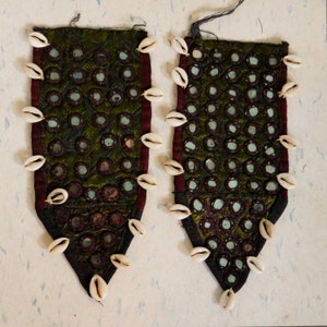 May include: Two green fabric panels with a decorative pattern of small round mirrors and white shell accents. The panels are trimmed with a dark red fabric.