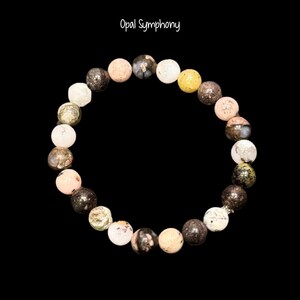 May include: A beaded bracelet with a variety of colorful, round stones. The bracelet features stones in shades of white, pink, yellow, black, and green. The text "Opal Symphony" is in the upper left corner.