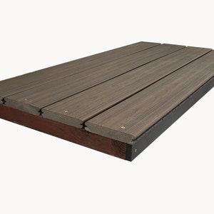 May include: A rectangular, composite deck platform with a dark brown wood grain appearance. The platform is constructed of several parallel planks, secured to a dark brown frame with black edging. The deck is designed for outdoor use.