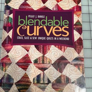 May include: A book titled "blendable Curves" by Peggy J. Barkle. The cover features a quilt design with diamond shapes in shades of red, purple, and cream, with the text "Stack, Slice & Sew Unique Quilts in a Weekend".