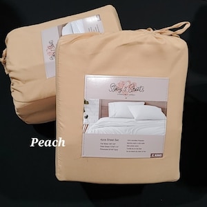 May include: Peach-colored 4-piece King sheet set in packaging. The packaging features the text "Stacy's Sheets" and a picture of the sheets. The set includes a flat sheet, fitted sheet, and pillowcases. The set is made of 100% microfiber polyester.