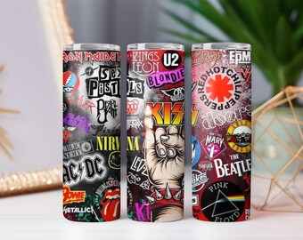 May include: Three stainless steel tumblers with rock band logos and graphics. The tumblers feature logos from bands like AC/DC, KISS, and The Beatles. The background is white.