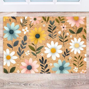May include: A doormat with a floral design featuring yellow, white, blue, and pink flowers on a brown background.