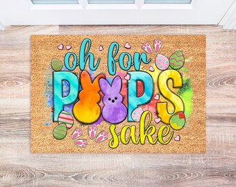 May include: A rectangular doormat with the phrase "oh for Peeps sake" in a colorful, whimsical design. The design includes Easter eggs, bunny shapes, and paw prints, perfect for the Easter holiday.