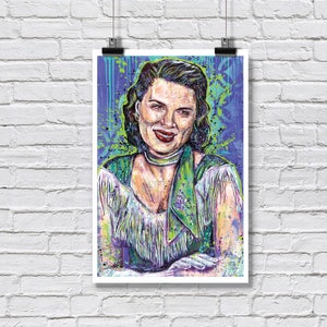 May include: A vibrant, multi-colored art print featuring a portrait of a person with dark hair, wearing a green scarf and a white fringed garment. The artwork uses expressive, splattered paint techniques in shades of purple, blue, and green.