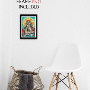 May include: A framed print of a colorful illustration of a person with a beard and long hair. The person is wearing a red robe and has a halo above their head. The text "I INTICHE YOU A CREATION" is written above the person's head. The text "YOU GOTTA" is written below the person's head.