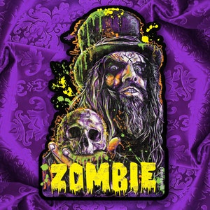 May include: A colorful sticker featuring a portrait of a man with long, dark hair and a top hat. He is holding a skull in his left hand. The word "ZOMBIE" is written in yellow letters at the bottom of the sticker.