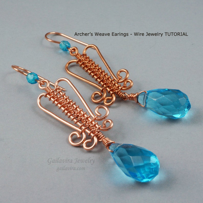May include: A pair of copper wire earrings with a woven design and teardrop-shaped blue crystals. The earrings are handmade and feature a unique, intricate design.