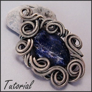 May include: A handcrafted pendant featuring a dark blue stone, intricately wrapped in silver-colored wire. The wire is coiled in a decorative pattern around the stone, creating a unique, artistic design. The word "Tutorial" is written in the bottom left corner.