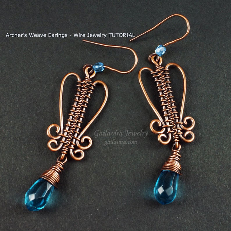 May include: A pair of copper wire earrings with a woven design and blue teardrop crystals. The earrings are handmade and feature a delicate, intricate design. The earrings are labeled "Galiavira Jewelry" and "galiavira.com".