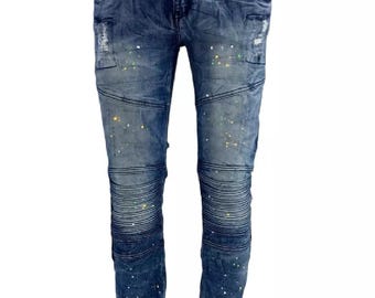 May include: Blue denim jeans with a paint splatter design and knee paneling.