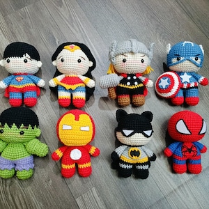 May include: A collection of eight crocheted superhero characters, including Superman, Wonder Woman, Thor, Captain America, Hulk, Iron Man, Batman, and Spiderman. Each character is unique and detailed, with recognizable features and accessories.