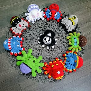 May include: A collection of 10 crocheted octopus plushies in various colors and designs. The octopus plushies are arranged in a circle on a crocheted surface.