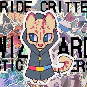 May include: A sticker featuring a cartoon animal wearing a blue hooded robe with a rainbow pride flag on the belt. The animal has a light brown body with pink spots and blue eyes. The sticker is surrounded by other stickers with various designs.