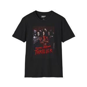 May include: Black t-shirt with a graphic from Michael Jackson's "Thriller." The design includes a red title and a group of zombies. The shirt is from Threaded Nation.