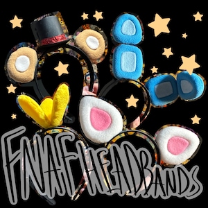 May include: A collection of black headbands featuring plush character ears and accessories, including a small black top hat with a red glitter band, yellow pointed ears, blue rectangular ears, and white ears with pink centres, accented by yellow stars.