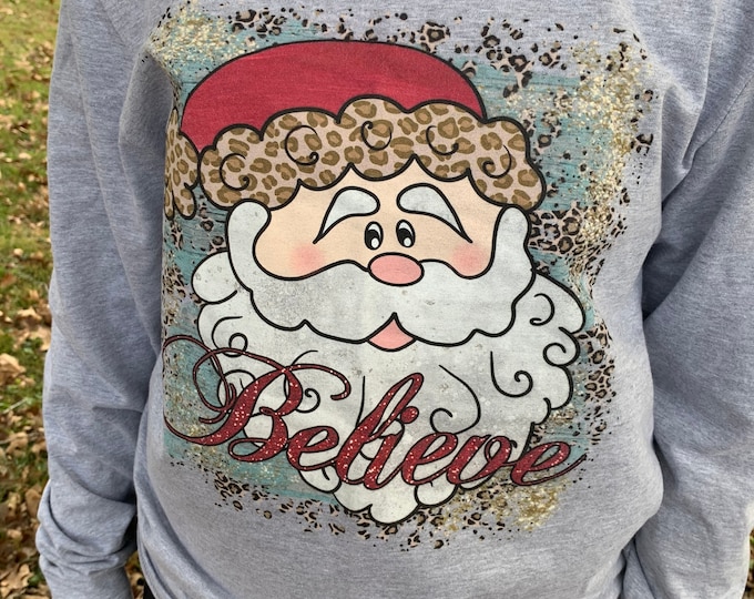 Featured listing image: Leopard Santa “Believe” T-shirt