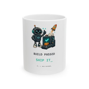 Puede incluir: Una taza de cerámica blanca con un robot de dibujos animados haciendo un gesto de pulgar hacia arriba junto a una cinta transportadora con un cohete despegando. El texto dice BUILD PASSED, SHIP IT y FP // BUILT DIFFERENT.