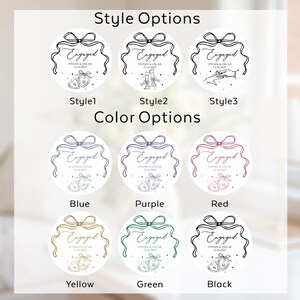 May include: A collection of circular stickers featuring engagement designs. The text reads Engaged, Vivian & Oscar, and 12.16.2025. Style options include hearts, champagne flutes, or hands with a ring. Color options are blue, purple, red, yellow, green, and black.