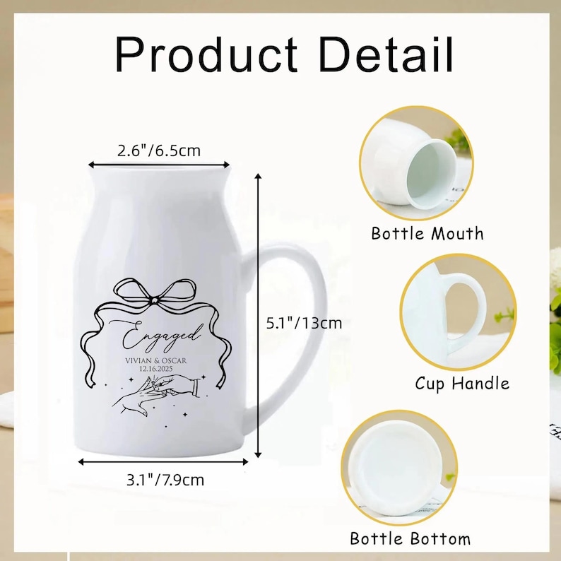 May include: A white ceramic mug with a handle, featuring a black line drawing of a bow, hands exchanging a ring, and the text Engaged, Vivian & Oscar, 12.16.2025. Dimensions are 2.6 inches wide at the mouth, 3.1 inches at the base, and 5.1 inches tall.